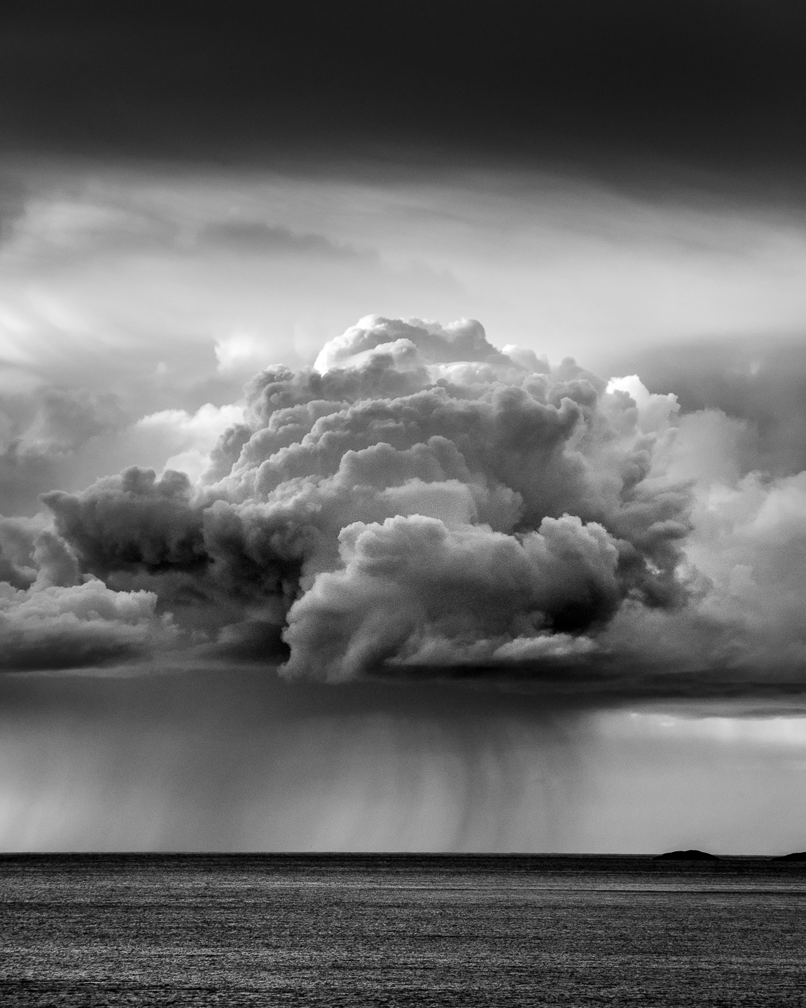 Black and white of big cloud over sea, Senja, Norway