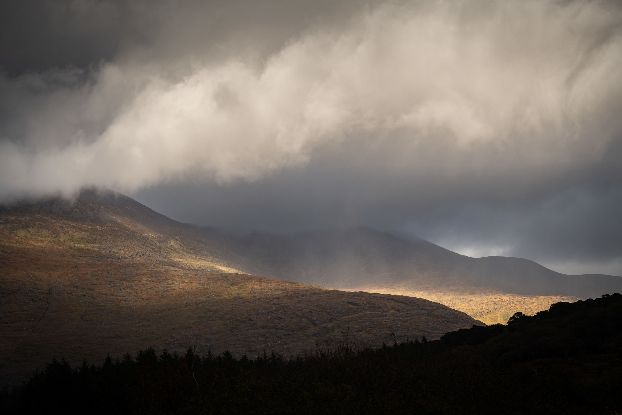 Black valley light on hills