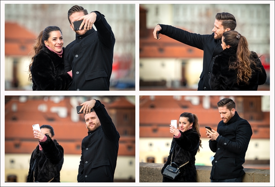 Couple doing mobile phone selfies on Charles Bridge Prague, Czech Republic